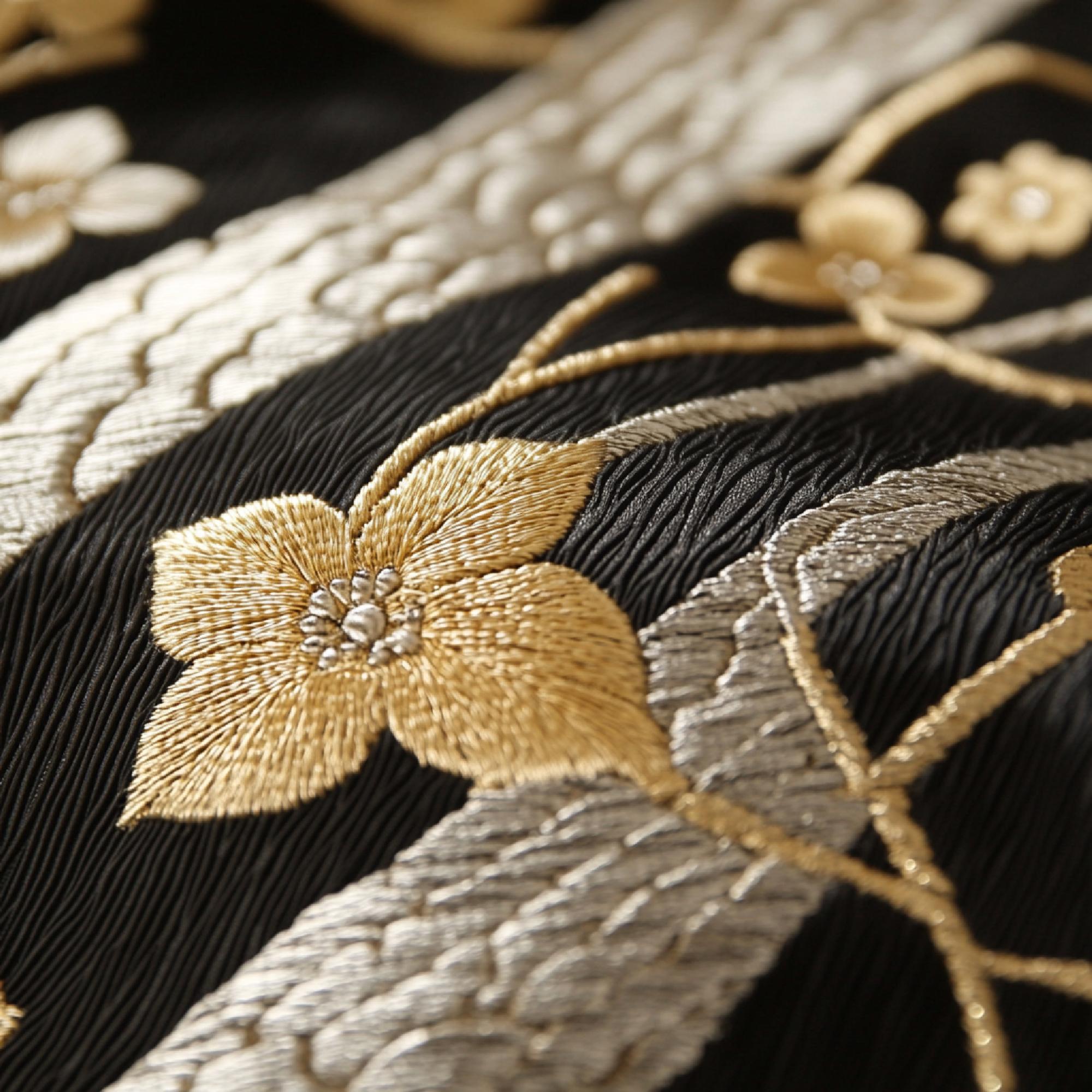 close-up of gold thread embroidery on cream fabric
